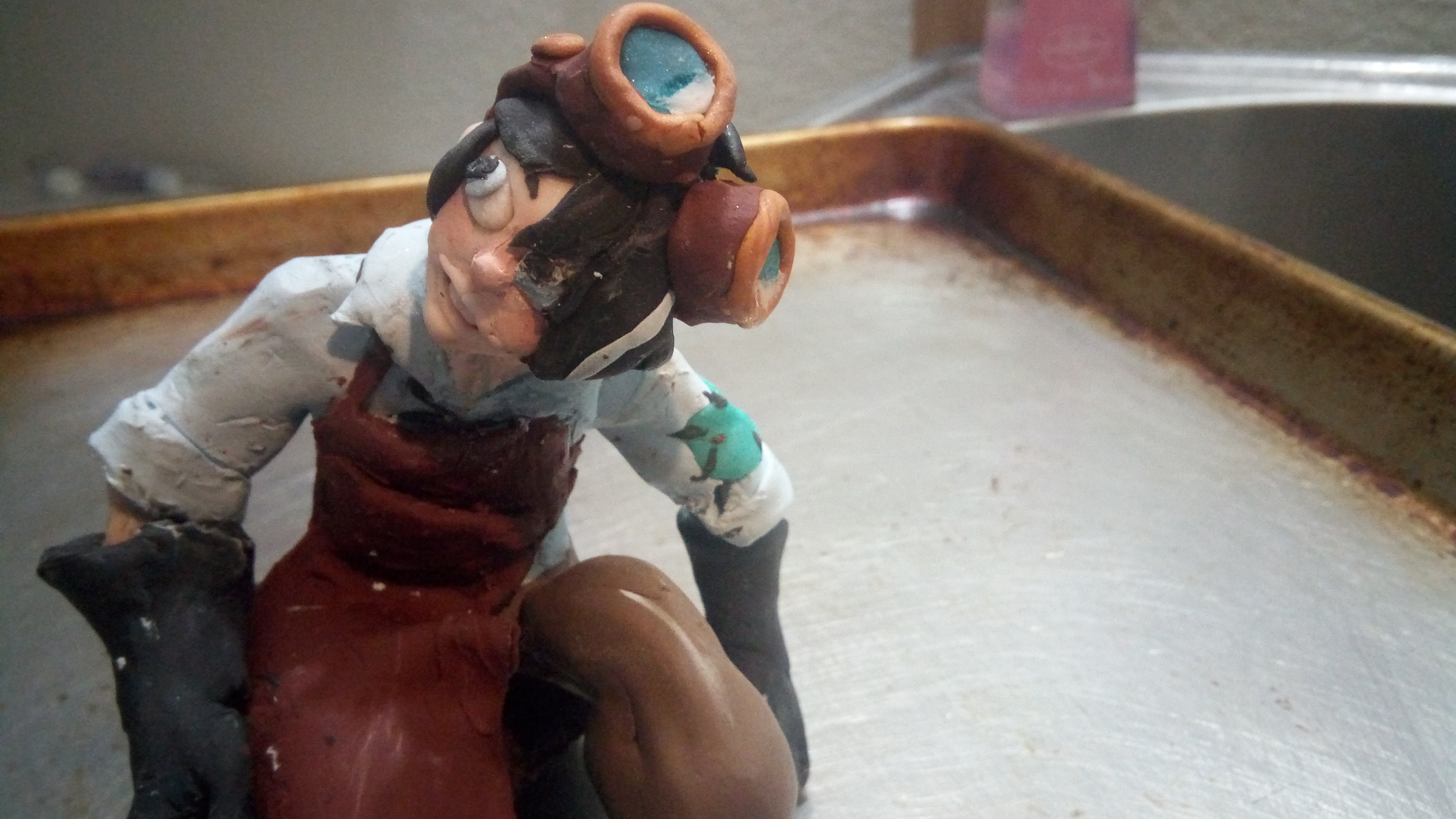 Clost up of clay figure of a boy wearing goggles